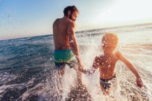 Hoburne Holidays - Man and son playing in sea