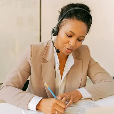Researcher on a headset handeling a telephone mystery shop
